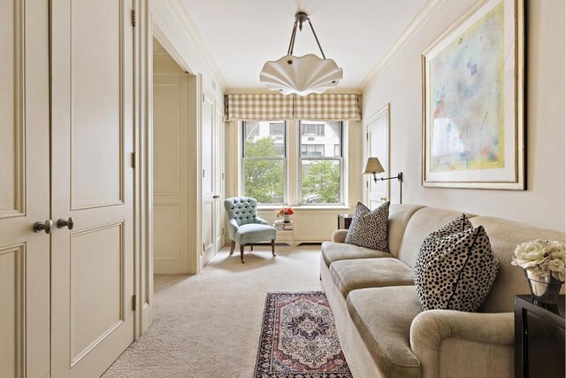 carpeted living room featuring ornamental molding