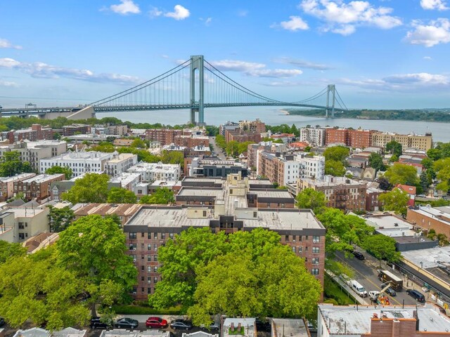 drone / aerial view featuring a water view and a city view