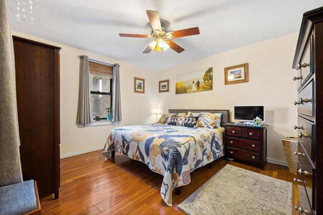 bedroom featuring ceiling fan and dark hardwood / wood-style flooring