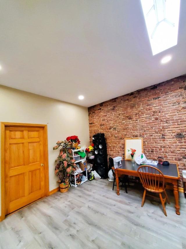 office with a skylight, baseboards, recessed lighting, and wood finished floors