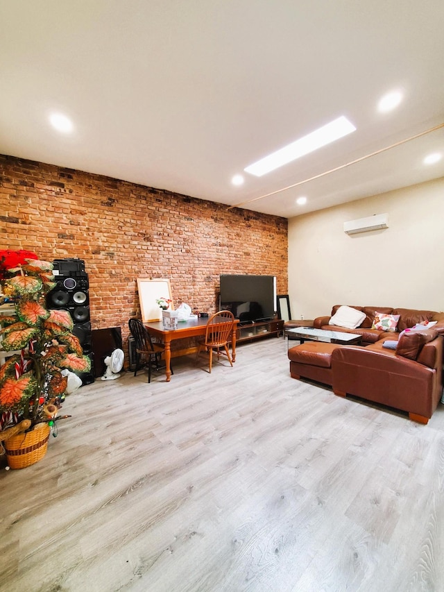 living room with recessed lighting, a wall unit AC, wood finished floors, and brick wall