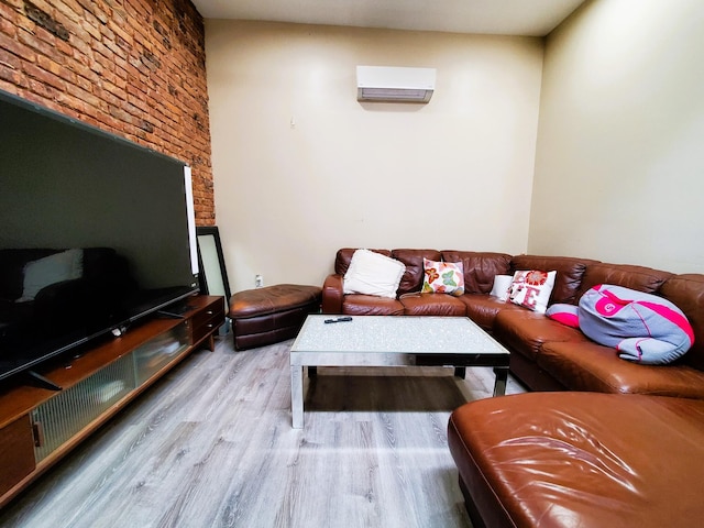 living room with a wall mounted air conditioner and wood finished floors