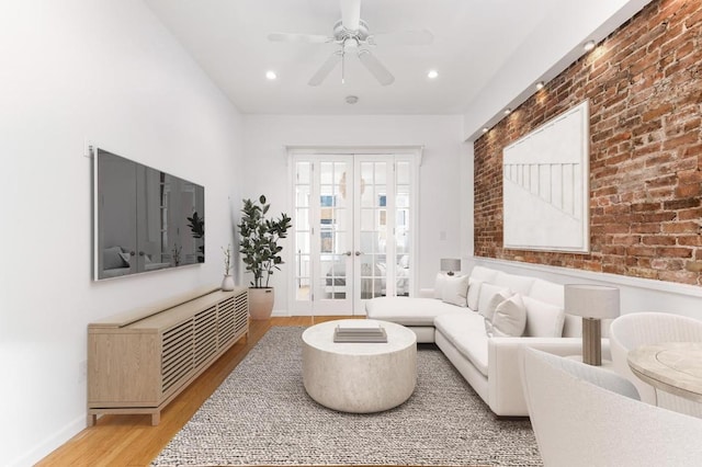 living area featuring recessed lighting, brick wall, a ceiling fan, french doors, and light wood-type flooring