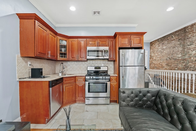 kitchen with crown molding, stainless steel appliances, visible vents, and a sink