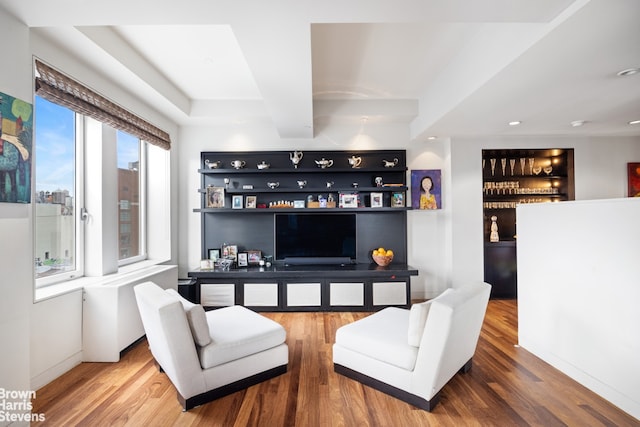 living room featuring built in features, recessed lighting, beamed ceiling, and wood finished floors