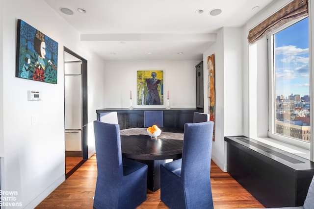 dining space featuring breakfast area and wood finished floors