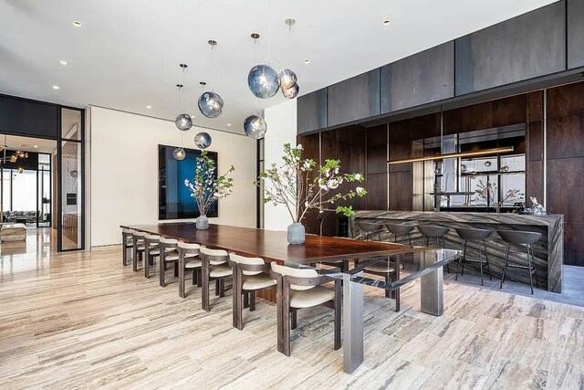 dining area featuring floor to ceiling windows and light hardwood / wood-style flooring