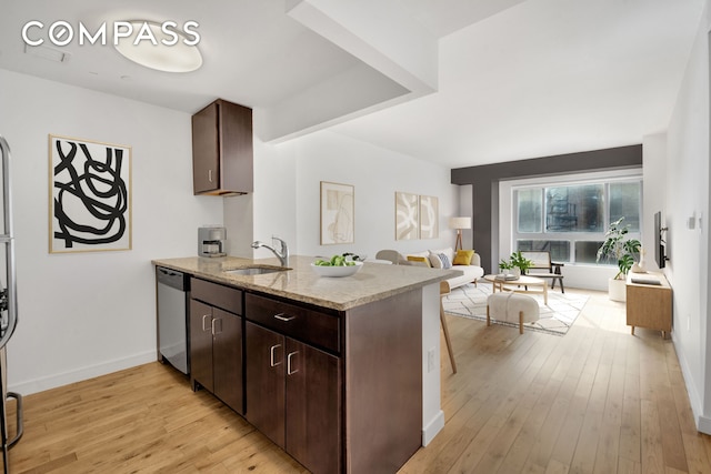 171 W 131st St Unit 304, New York City, NY 10027 - kitchen featuring dishwasher, a peninsula, open floor plan, light wood finished floors, and light stone counters