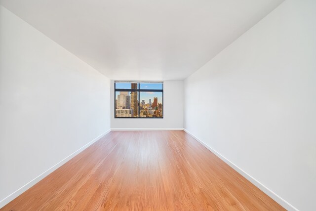 unfurnished room with light hardwood / wood-style floors