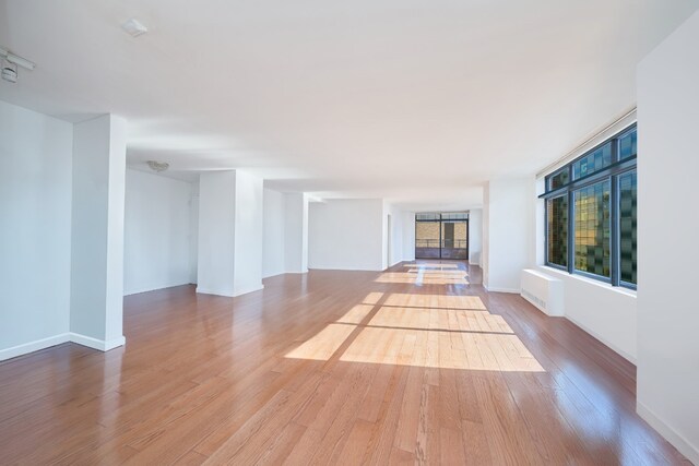 unfurnished living room featuring light wood-type flooring