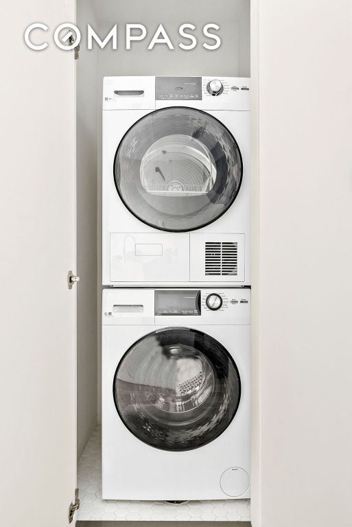 laundry room featuring stacked washer and clothes dryer