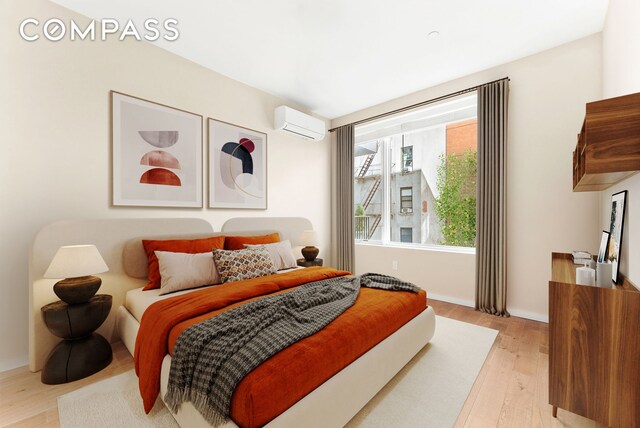 bedroom featuring light hardwood / wood-style floors and a wall unit AC