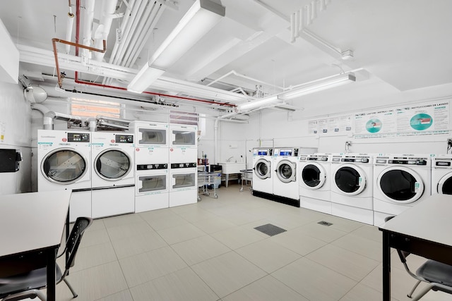 community laundry room featuring tile patterned flooring, washing machine and dryer, and stacked washer and clothes dryer