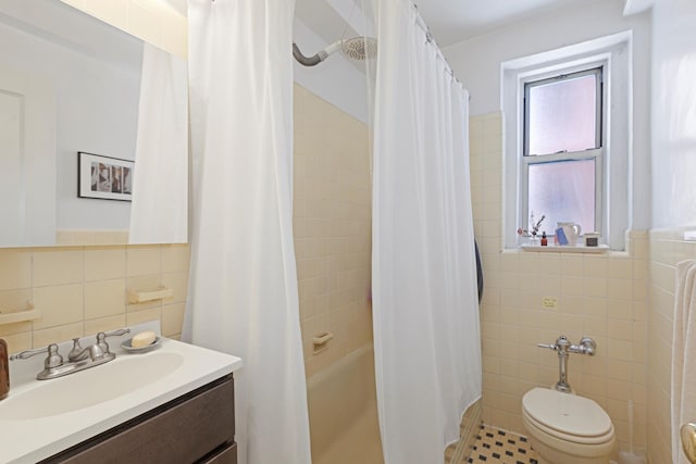 bathroom featuring shower / bath combo with shower curtain, toilet, tile walls, and vanity