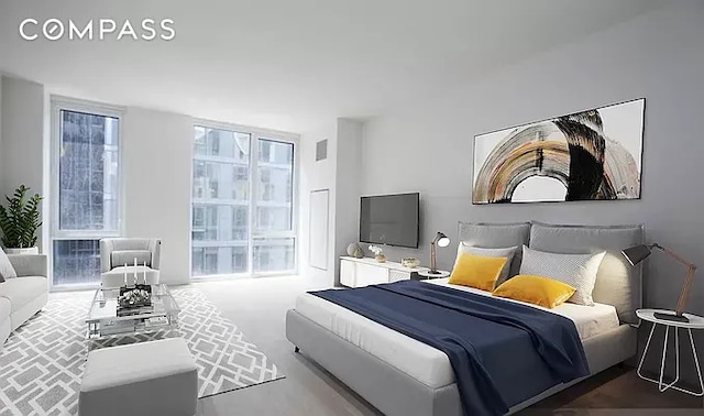 bedroom featuring floor to ceiling windows and visible vents