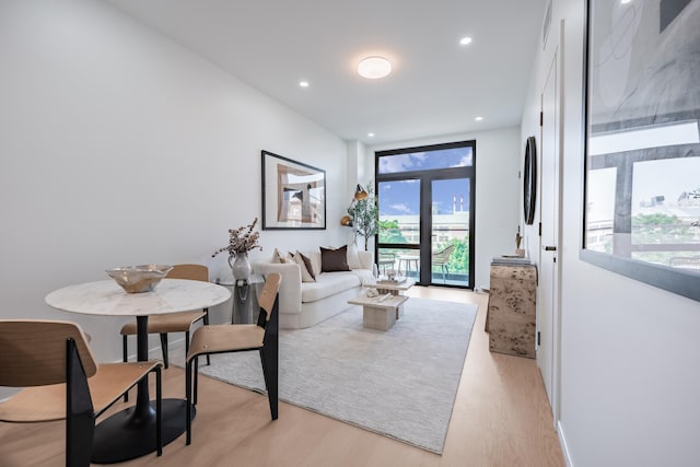 living area with light wood-style floors and recessed lighting