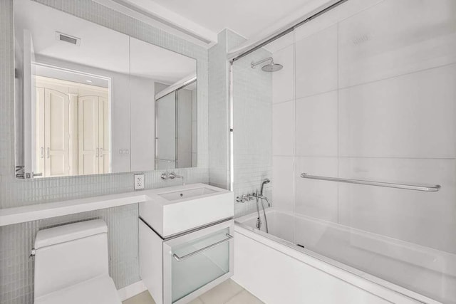 full bathroom with enclosed tub / shower combo, visible vents, vanity, and toilet