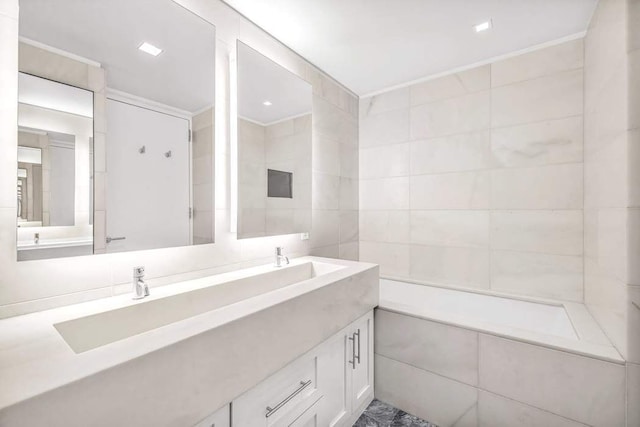 full bath featuring double vanity and tile walls