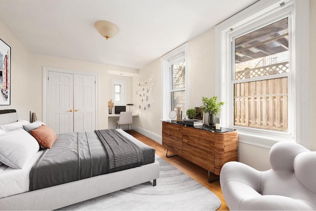 bedroom with hardwood / wood-style flooring and a closet