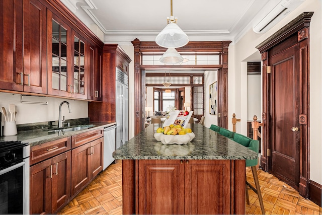 kitchen featuring ornamental molding, a wall unit AC, a sink, and appliances with stainless steel finishes