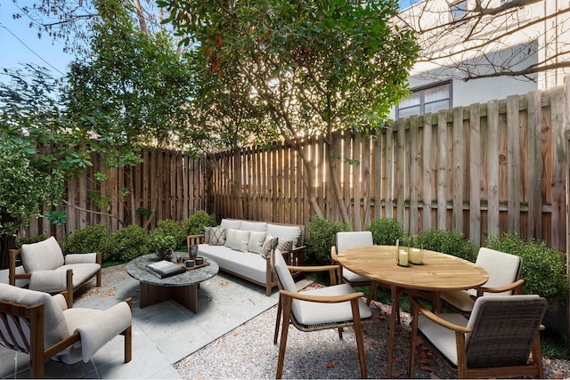 view of patio / terrace featuring an outdoor hangout area, outdoor dining area, and a fenced backyard