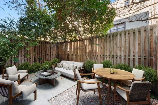 view of patio / terrace with outdoor lounge area, outdoor dining space, and a fenced backyard
