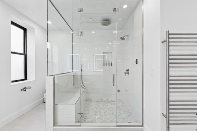 bathroom with radiator and an enclosed shower