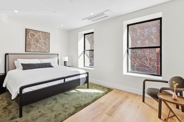 bedroom with hardwood / wood-style flooring