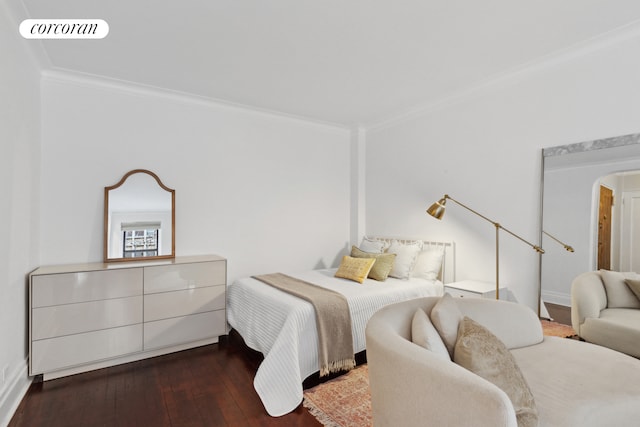 bedroom with ornamental molding, hardwood / wood-style flooring, and baseboards