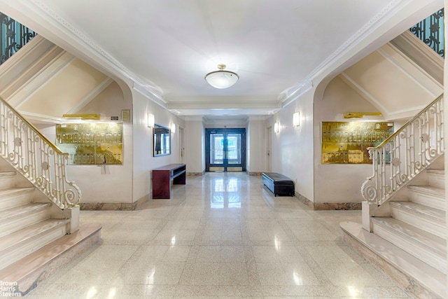 interior space with arched walkways, granite finish floor, stairs, and baseboards