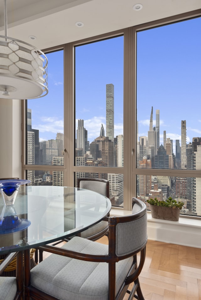 dining area featuring a view of city and wood finished floors