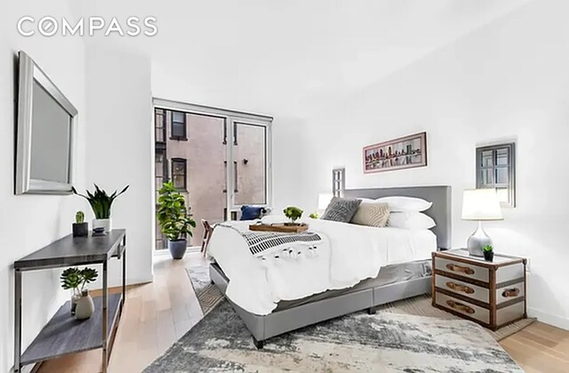 540 W 49th St Unit 406N, New York City, NY 10019 - bedroom with wood finished floors and baseboards
