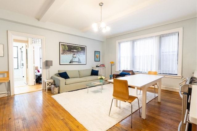 living room featuring hardwood / wood-style floors, beam ceiling, and a chandelier