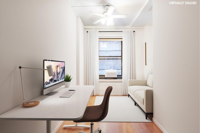 home office featuring a ceiling fan, baseboards, and wood finished floors