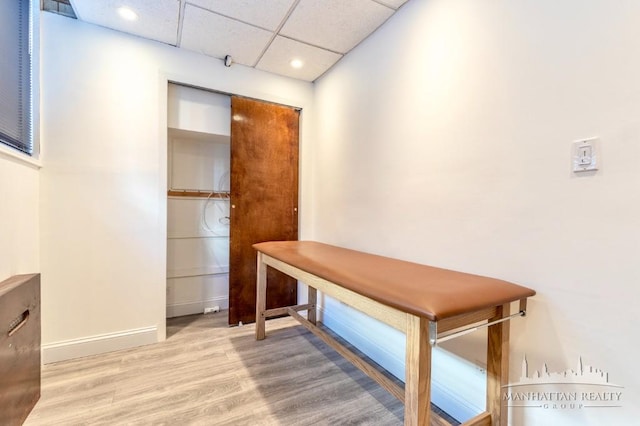 interior space with visible vents, wood finished floors, recessed lighting, a paneled ceiling, and baseboards