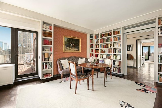 sitting room featuring wood finished floors and built in features