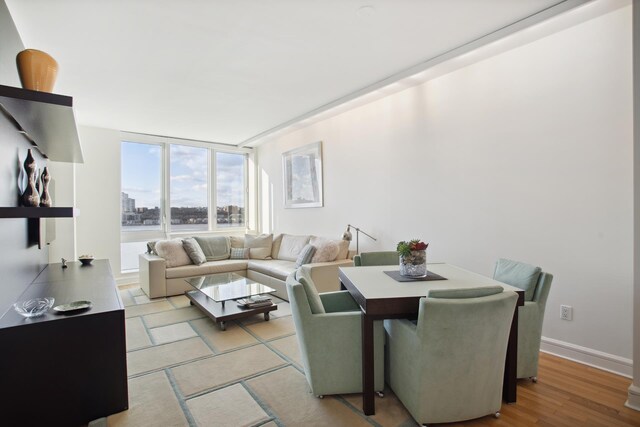 dining space featuring a wall of windows and light hardwood / wood-style floors