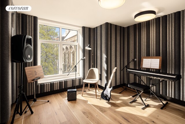 interior space featuring light wood-type flooring and wallpapered walls