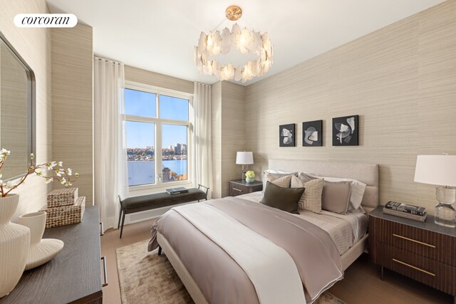 bedroom featuring wood finished floors and a notable chandelier