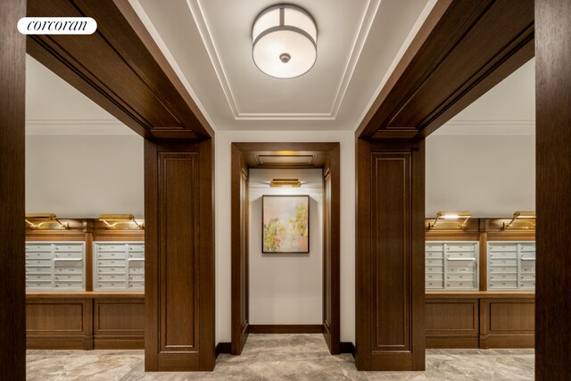 hallway featuring baseboards, visible vents, and mail area