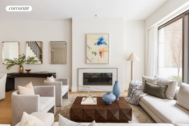 living room featuring a fireplace, wood finished floors, and visible vents
