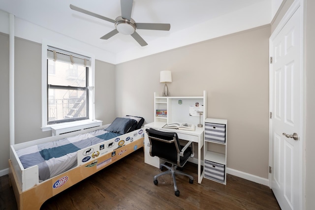 bedroom featuring wood finished floors, baseboards, and ceiling fan