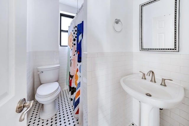 779 Riverside Dr Unit C43, New York City, NY 10032 - full bathroom with tile walls, toilet, a wainscoted wall, a sink, and a shower with curtain