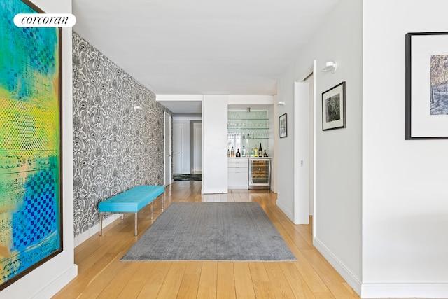 hallway featuring wood-type flooring and beverage cooler