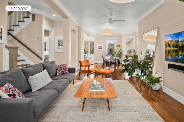 living room featuring crown molding, ceiling fan, and wood-type flooring