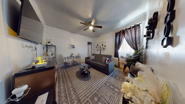 living area featuring radiator and ceiling fan