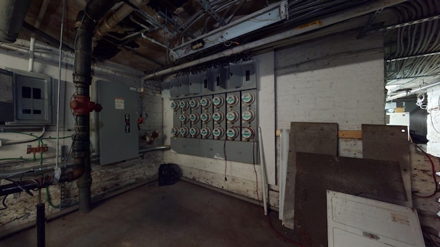 unfinished basement featuring heating unit and electric panel