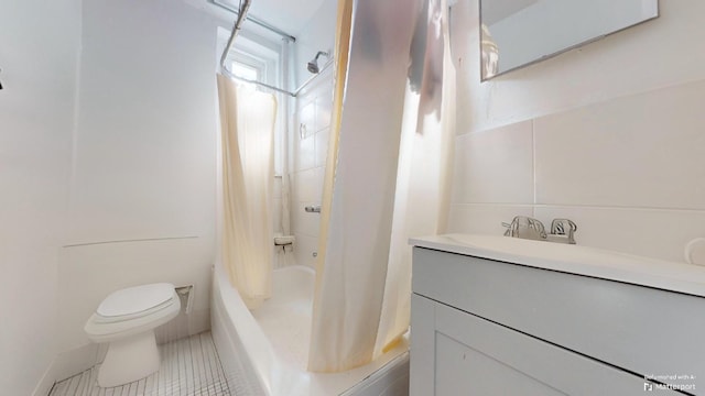 full bathroom with shower / tub combo, toilet, vanity, and tile patterned flooring