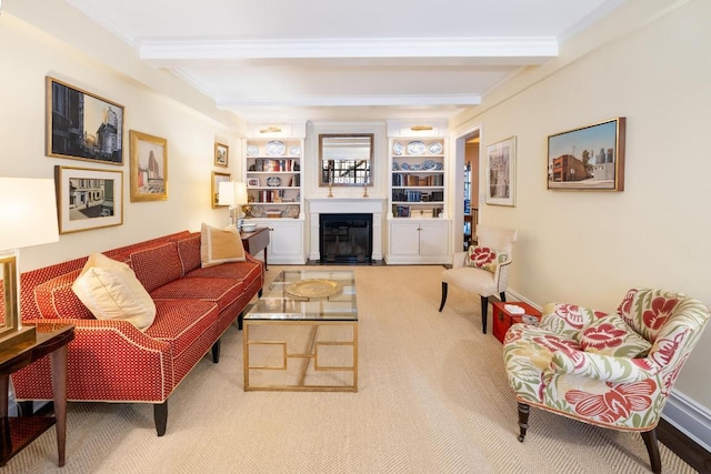 carpeted living room with ornamental molding, beamed ceiling, and built in shelves