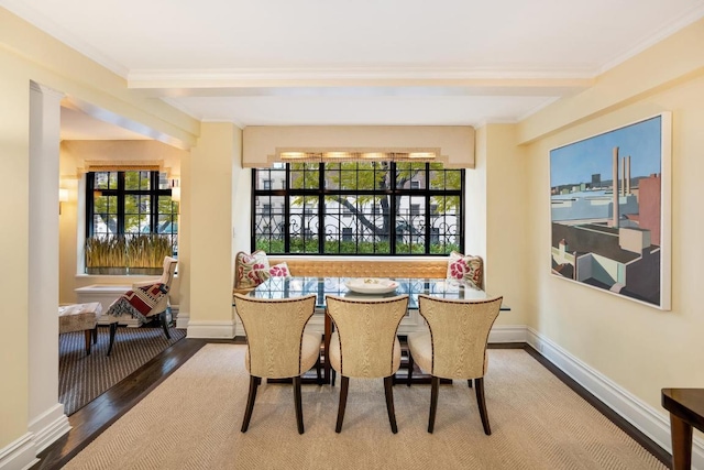 dining space featuring crown molding and hardwood / wood-style flooring